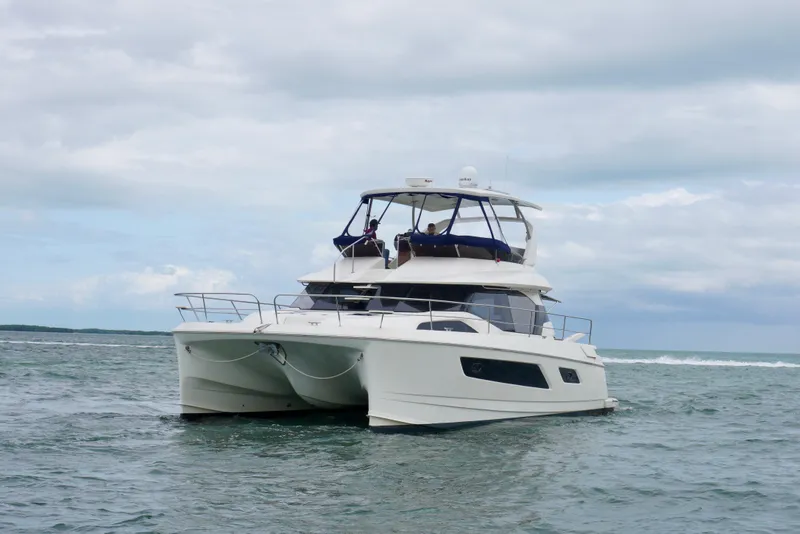 Slide: The Image of 2017 Aquila 44 Yacht cruising on open water under cloudy skies. - 2