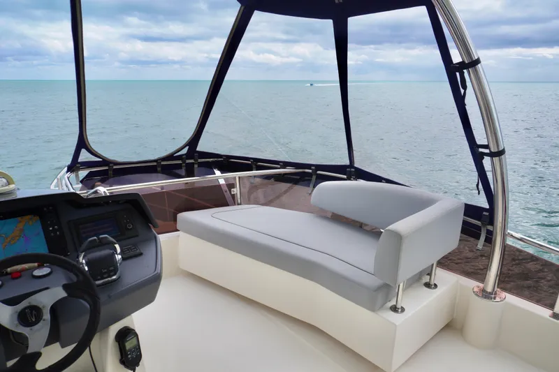 Slide: The Image of Aquila 44 Yacht 2017 helm with ocean view, featuring modern seating and navigation controls. - 21