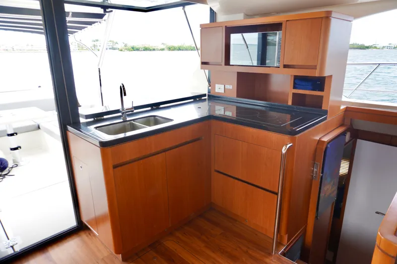 Slide: The Image of Luxurious kitchen interior of 2017 Aquila 44 Yacht with wooden cabinetry and modern appliances. - 23