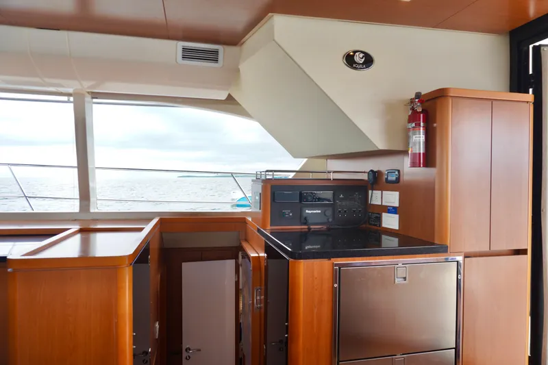 Slide: The Image of Interior of 2017 Aquila 44 Yacht with wooden cabinetry and ocean view. - 24