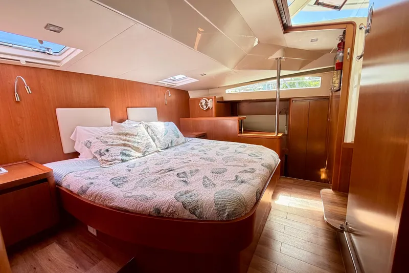 Slide: The Image of Luxurious 2017 Aquila 44 Yacht bedroom with wood paneling and skylights. - 29