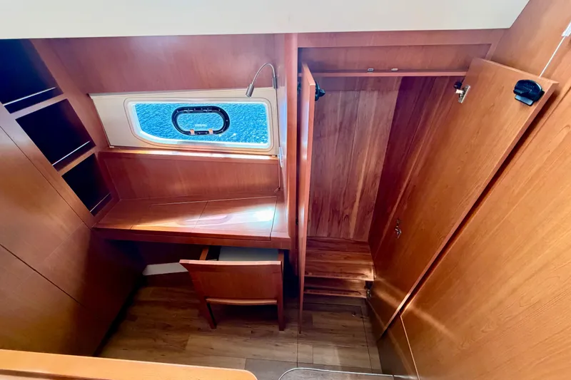Slide: The Image of 2017 Aquila 44 Yacht interior with wooden desk, chair, and window view. - 31