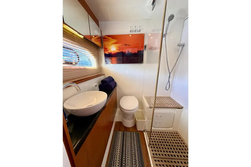 Slide: The Image of Luxurious bathroom in 2017 Aquila 44 Yacht with modern fixtures and sunset artwork. - 35