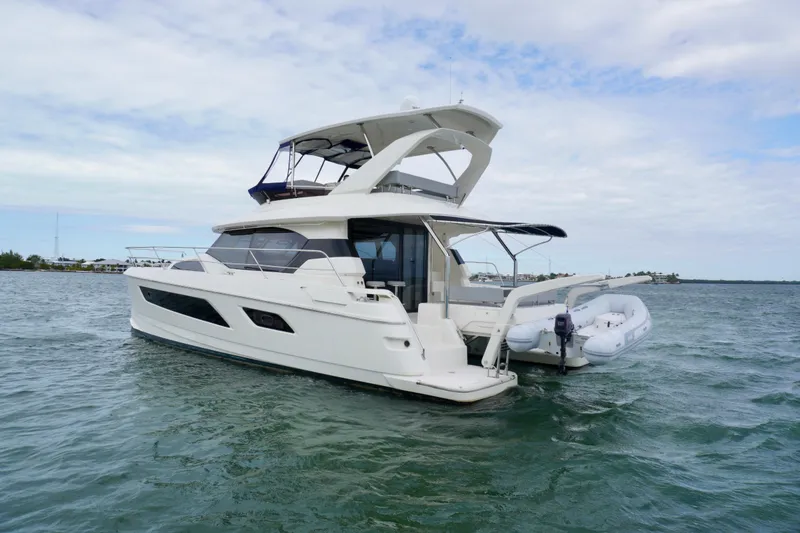 Slide: The Image of 2017 Aquila 44 Yacht cruising on open water under a cloudy sky. - 4
