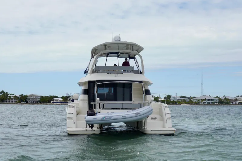 Slide: The Image of Aquila 44 Yacht 2017 on water, rear view with inflatable boat. - 5