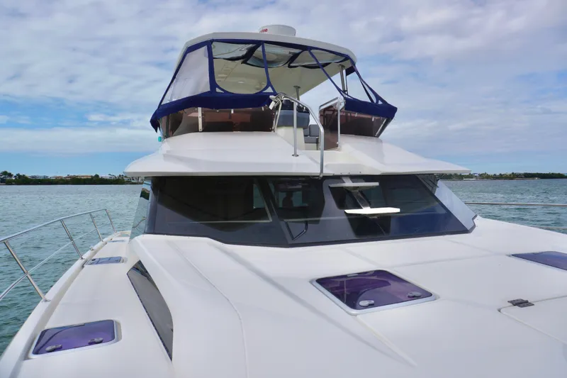 Slide: The Image of 2017 Aquila 44 Yacht on calm waters under a partly cloudy sky. - 8