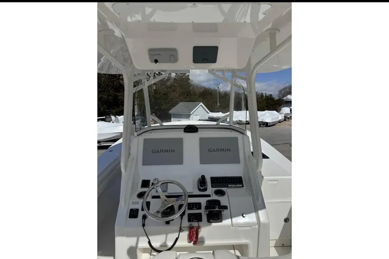 Slide: The Image of 2018 Regulator 34 Center Console boat dashboard with Garmin navigation system. - 16