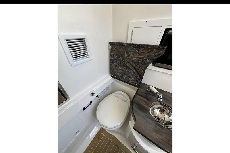 Slide: The Image of 2018 Regulator 34 Center Console boat interior with toilet and sink. - 20