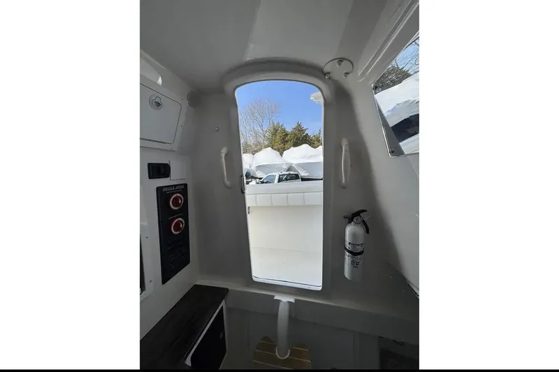 Slide: The Image of Interior view of 2018 Regulator 34 Center Console boat with control panel and fire extinguisher. - 21