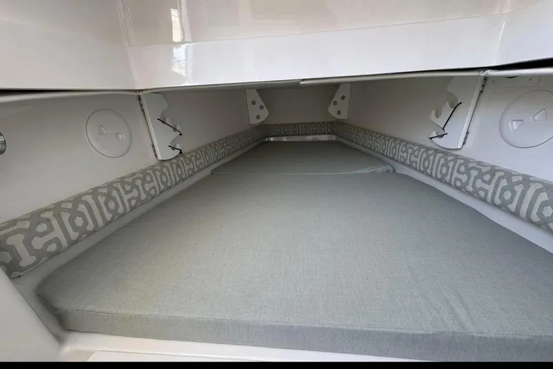 Slide: The Image of 2018 Regulator 34 Center Console cabin interior with cushioned sleeping area. - 22