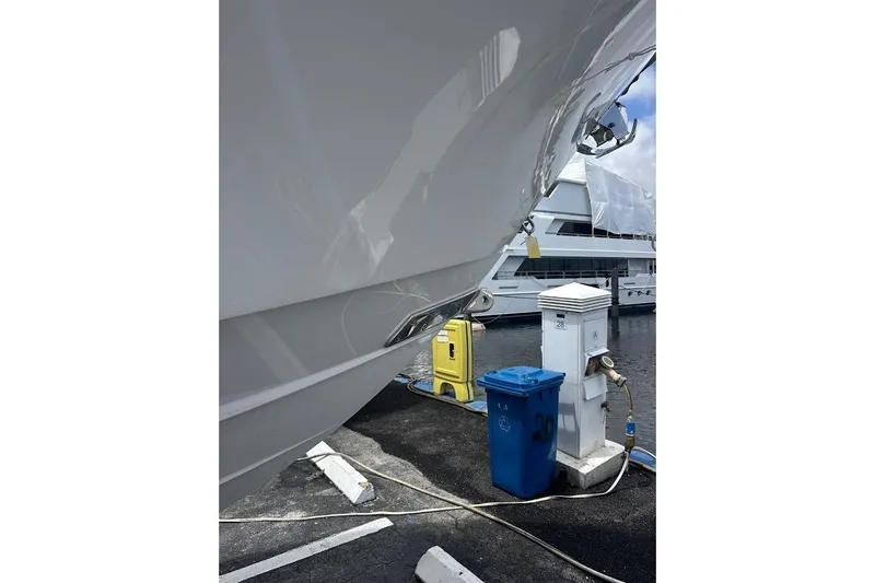 Slide: The Image of 2018 Regulator 34 Center Console docked, with marina utilities and recycling bin nearby. - 25