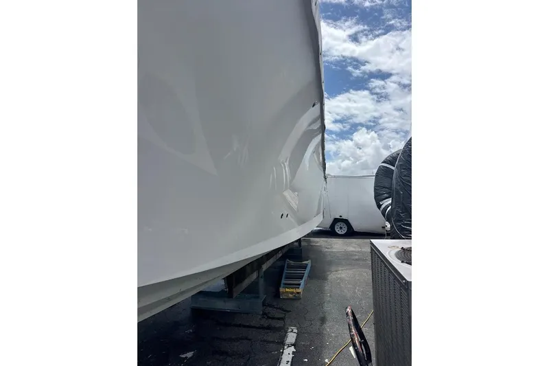 Slide: The Image of 2018 Regulator 34 Center Console boat hull under clear sky. - 27