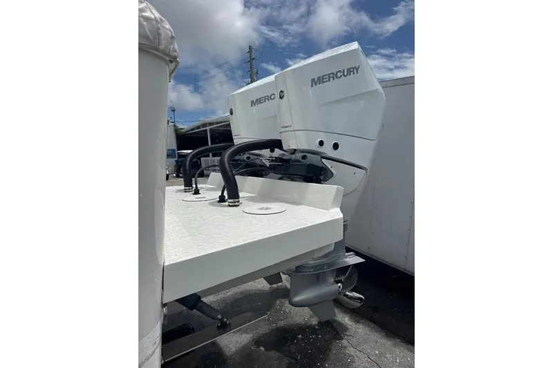 Slide: The Image of 2018 Regulator 34 Center Console with Mercury outboard engines, parked outdoors. - 8