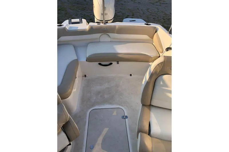 Slide: The Image of 2019 Stingray 191 LX boat interior with beige seating and storage compartment. - 7