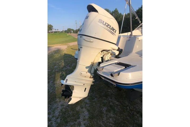 Slide: The Image of 2019 Stingray 191 LX boat with Suzuki outboard motor on grassy area. - 9