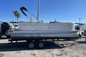 The Image of 2022 Godfrey Sweetwater 2286 C pontoon boat on trailer under clear blue sky. - 1