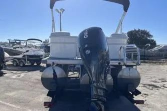 Slide: The Image of 2022 Godfrey Sweetwater 2286 C pontoon boat with outboard motor, parked outdoors. - 6