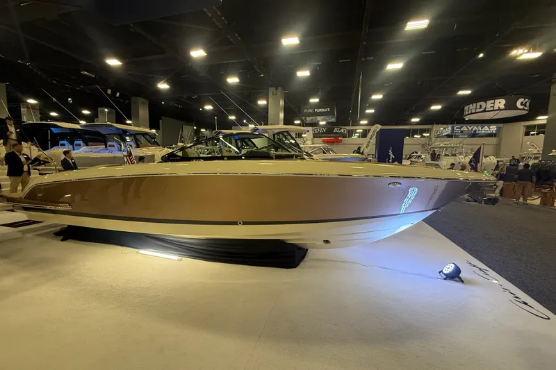 The Image of 2026 Chris-Craft Launch 27 boat showcased indoors at a boat show. - 15