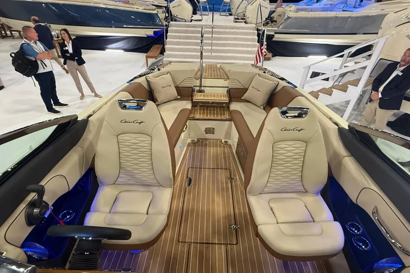 Slide: The Image of 2026 Chris-Craft Launch 27 boat interior with luxurious seating and wood finish. - 23