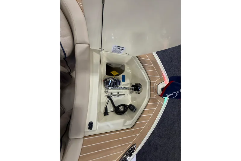 Slide: The Image of 2026 Chris-Craft Launch 27 boat interior with storage compartment and nautical equipment. - 28