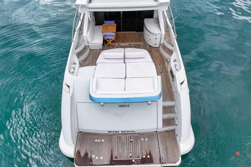 Slide: The Image of Azimut 68S 2006 yacht with spacious deck and seating, docked in clear blue water. - 11