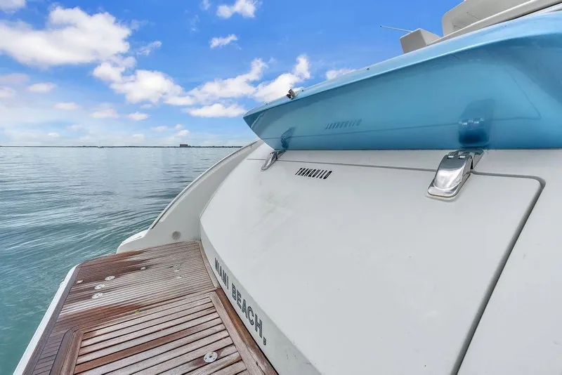 Slide: The Image of 2006 Azimut 68S yacht stern view with wooden deck, ocean backdrop. - 14