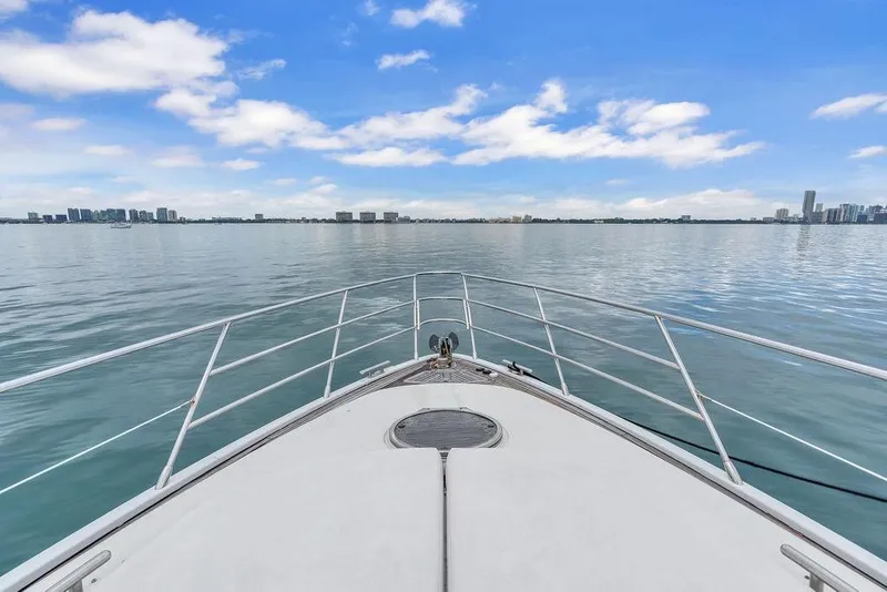 Slide: The Image of Bow view of 2006 Azimut 68S yacht cruising on calm waters under blue sky. - 17