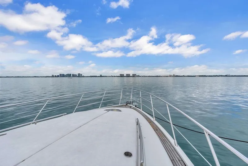 Slide: The Image of Bow view of 2006 Azimut 68S yacht on calm waters under blue sky. - 18