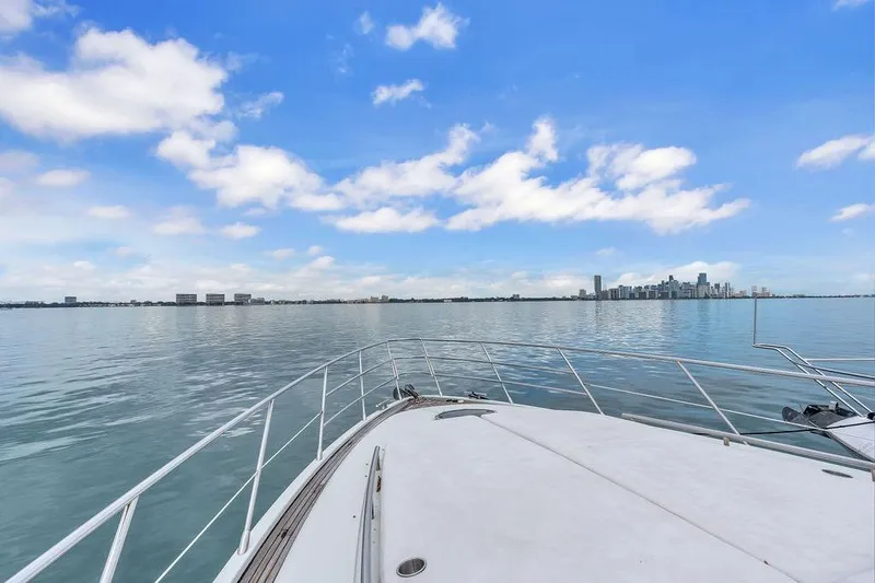 Slide: The Image of Bow view from 2006 Azimut 68S yacht, overlooking calm waters and city skyline. - 19