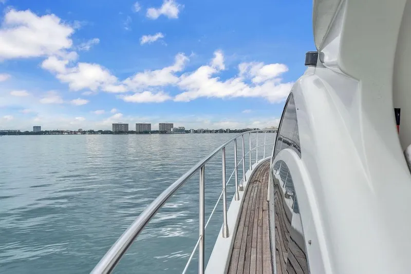 Slide: The Image of 2006 Azimut 68S yacht cruising on calm waters under a clear blue sky. - 20