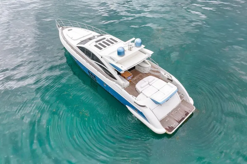 Slide: The Image of 2006 Azimut 68S luxury yacht on clear turquoise water, aerial view. - 3