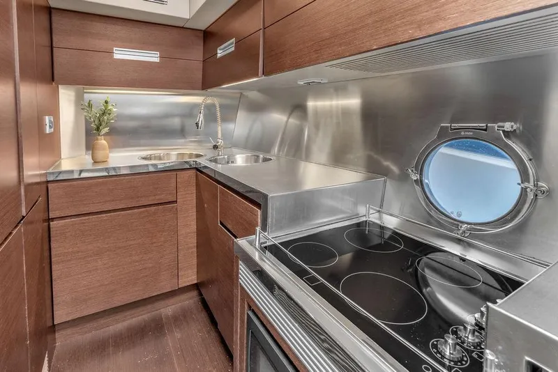 Slide: The Image of Modern kitchen in 2006 Azimut 68S yacht with stainless steel appliances and porthole window. - 37