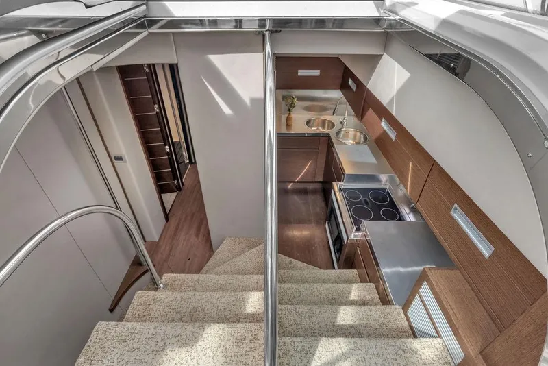 Slide: The Image of Interior view of 2006 Azimut 68S yacht, featuring modern kitchen and staircase. - 39