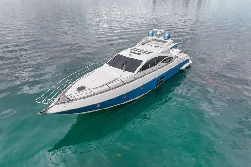 Slide: The Image of 2006 Azimut 68S yacht on calm turquoise water, showcasing sleek design and luxury. - 4