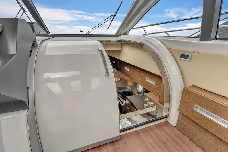 Slide: The Image of Interior view of 2006 Azimut 68S yacht kitchen with modern design and wood cabinetry. - 42