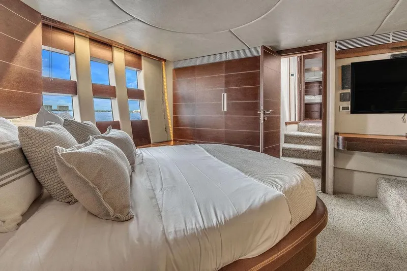 Slide: The Image of Luxurious bedroom interior of 2006 Azimut 68S yacht with modern design and large windows. - 48