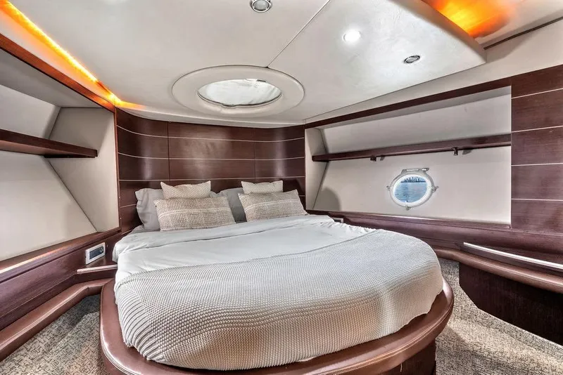 Slide: The Image of Luxurious bedroom interior of 2006 Azimut 68S yacht with elegant wood paneling. - 53