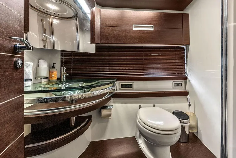 Slide: The Image of Luxurious bathroom in 2006 Azimut 68S yacht with modern fixtures and elegant wood accents. - 54