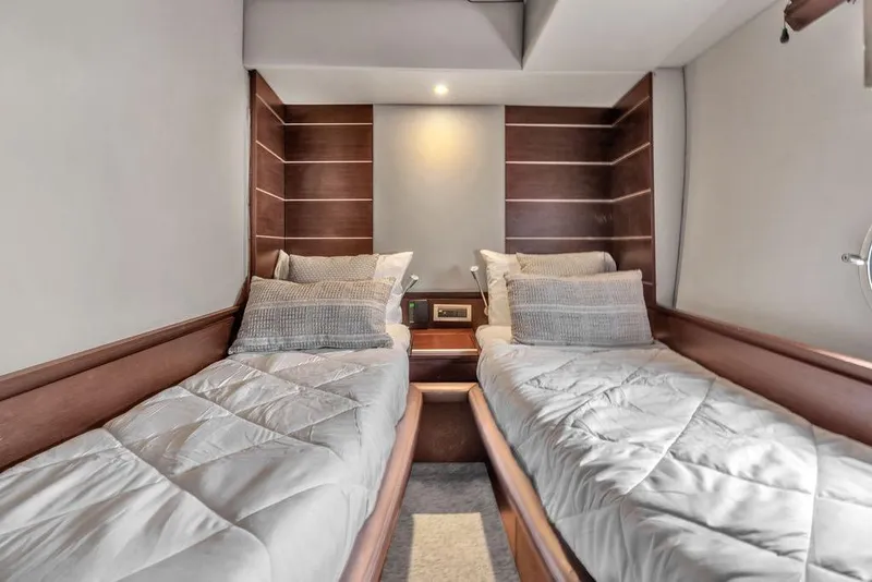 Slide: The Image of Luxurious twin cabin interior on a 2006 Azimut 68S yacht, featuring elegant wood paneling. - 56