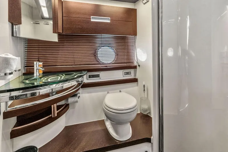 Slide: The Image of Luxurious bathroom in 2006 Azimut 68S yacht with modern fixtures and wooden accents. - 58