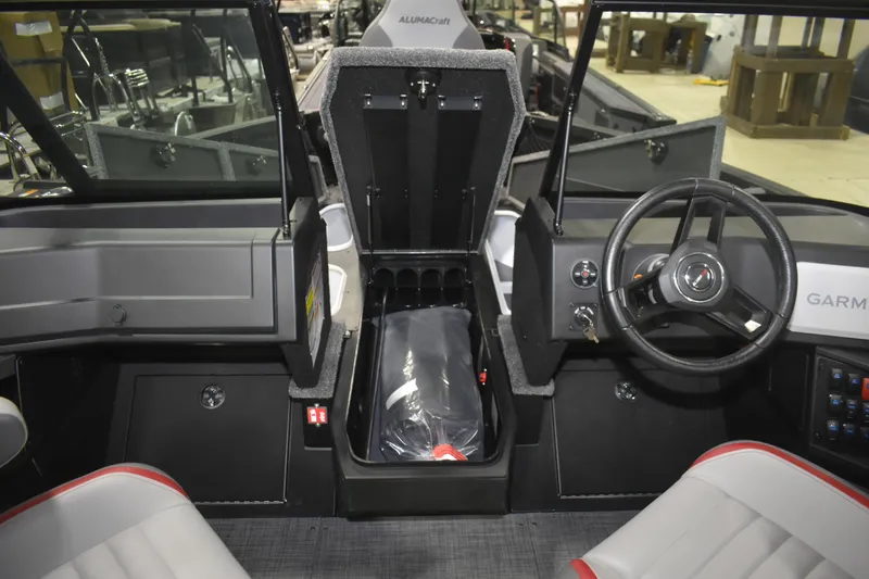 Slide: The Image of 2026 Alumacraft Trophy 175X Sport boat interior with steering wheel and storage compartment. - 11