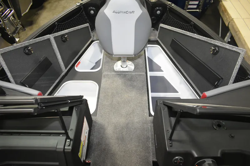 Slide: The Image of 2026 Alumacraft Trophy 175X Sport boat interior with storage compartments and seating. - 12