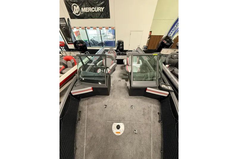 Slide: The Image of 2025 Alumacraft Trophy 175X Sport boat interior with seating and windshield, displayed indoors. - 17