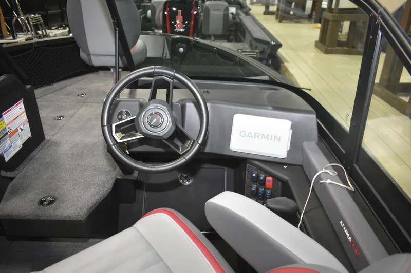 Slide: The Image of 2026 Alumacraft Trophy 175X Sport boat interior with steering wheel and Garmin navigation system. - 5