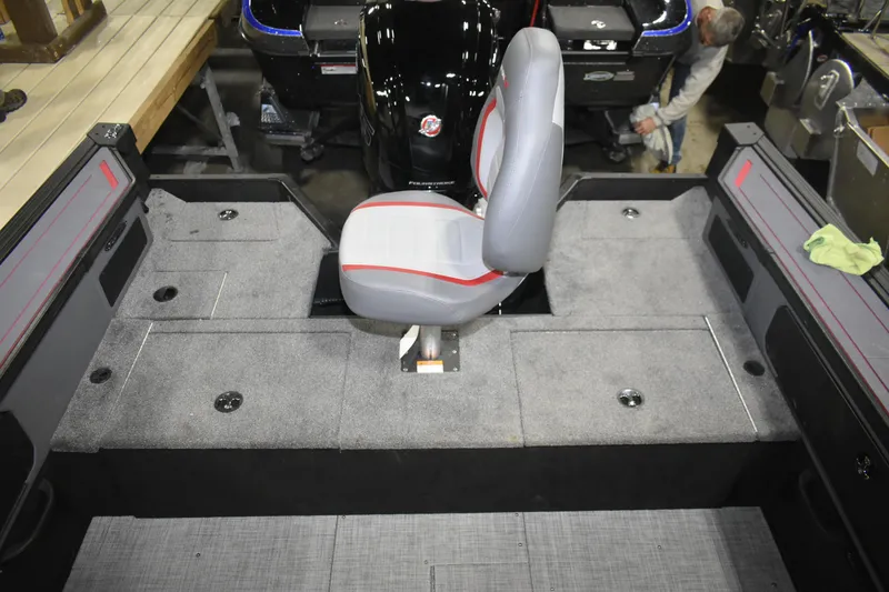 Slide: The Image of 2026 Alumacraft Trophy 175X Sport boat interior with gray seating and storage compartments. - 8