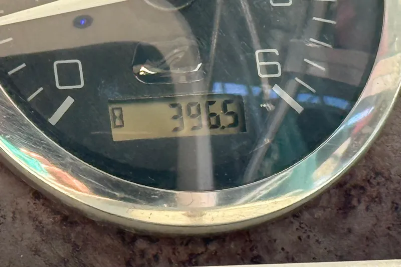 Slide: The Image of Close-up of a 1998 Sea Ray Sundancer 310 boat gauge displaying 396.5 hours. - 13