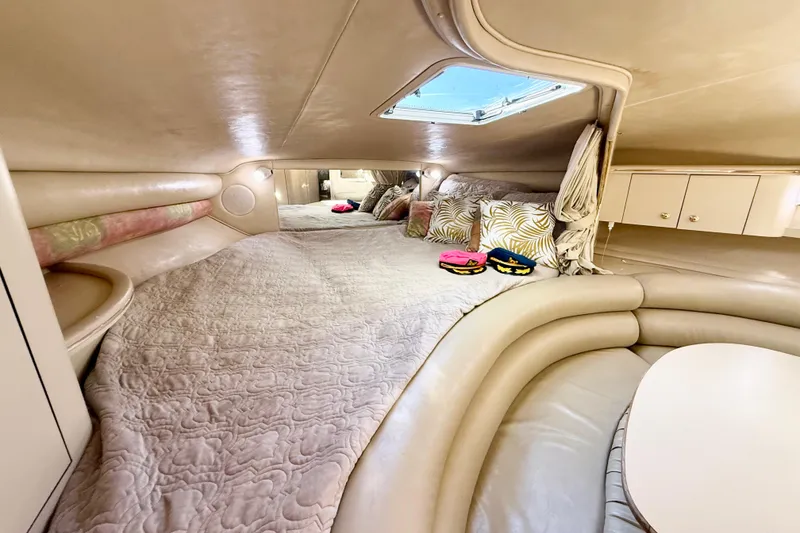 Slide: The Image of Luxurious interior of 1998 Sea Ray Sundancer 310 yacht with cozy bedding and elegant decor. - 18