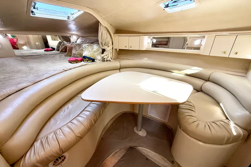 Slide: The Image of Luxurious interior of 1998 Sea Ray Sundancer 310 with cozy seating and elegant design. - 19