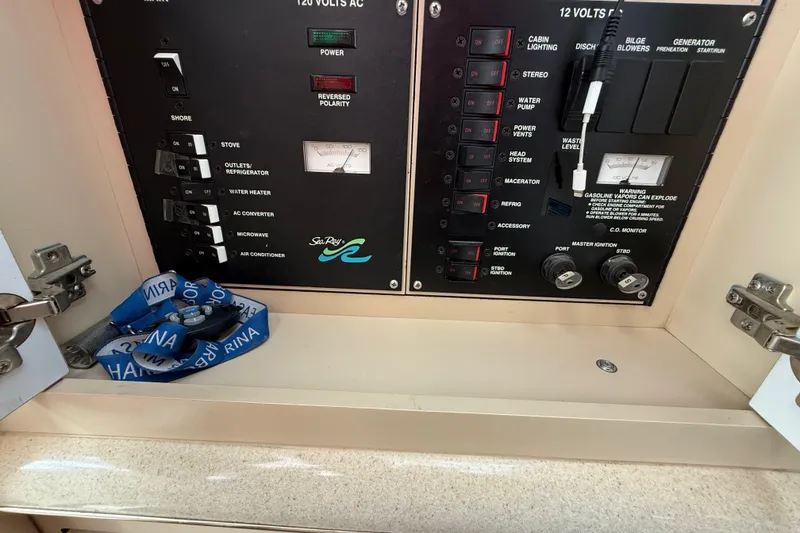 Slide: The Image of Electrical control panel of a 1998 Sea Ray Sundancer 310 boat, featuring various switches and indicators. - 25