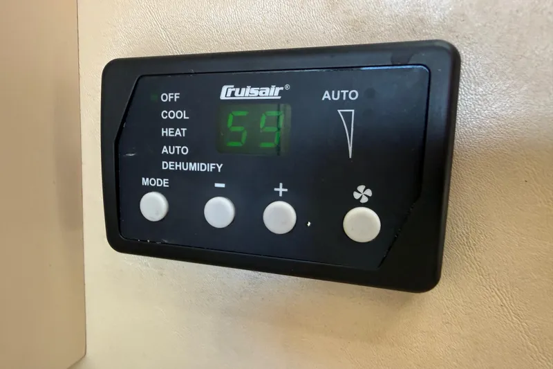 Slide: The Image of Cruisair control panel on 1998 Sea Ray Sundancer 310 boat, displaying temperature settings. - 29